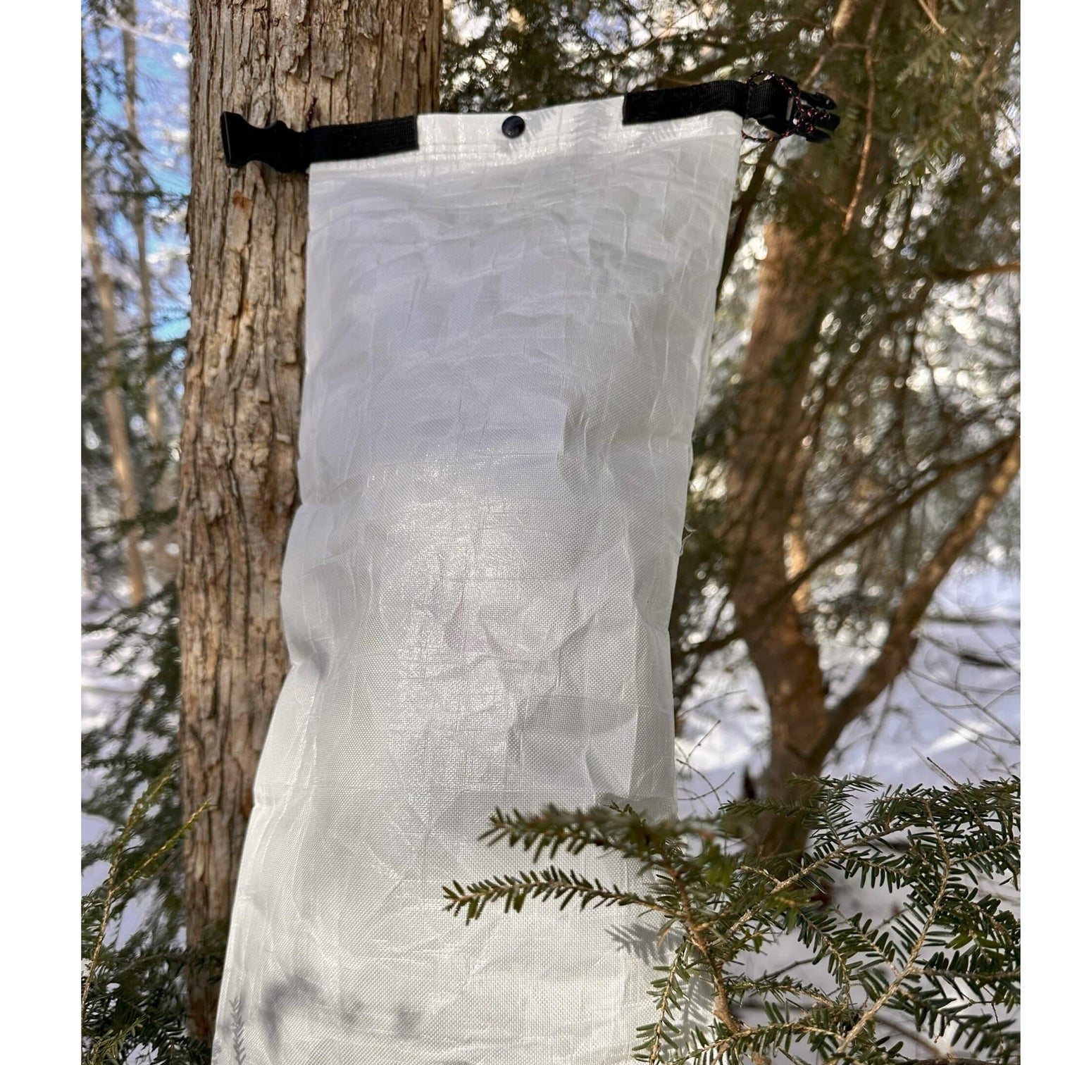 Ultralight Bear Locker 1 Adotec Gear Ultralight food storage for camping hanging from a tree in a forest setting