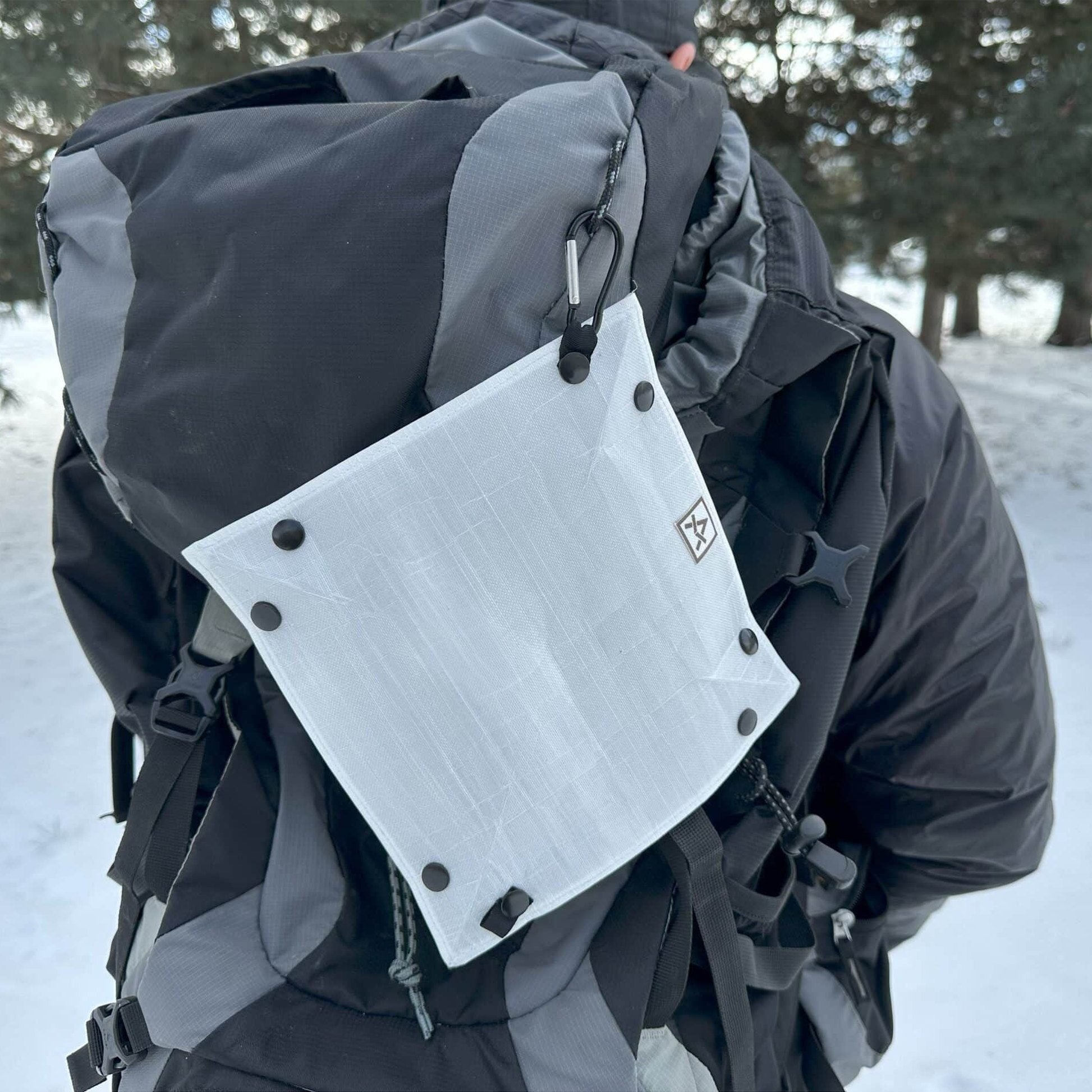 Ultralight Dog Bowl Adotec Gear Ultralight Camping Bowl attached to a backpack in snowy outdoor setting